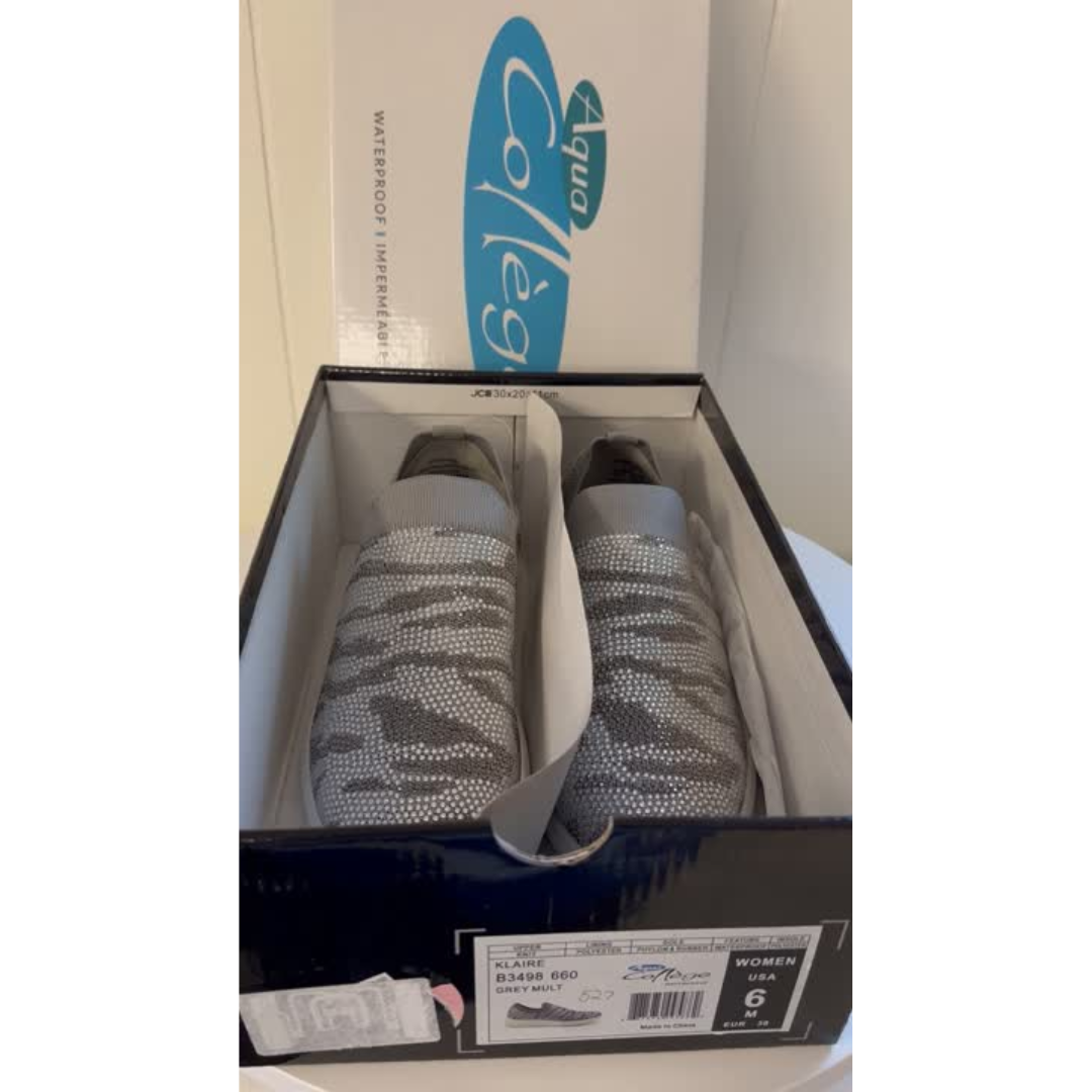 Gray sneakers in a box with Auqa College logo visible