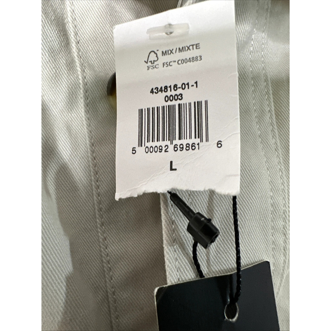 Clothing tag with barcode and text on a fabric background
