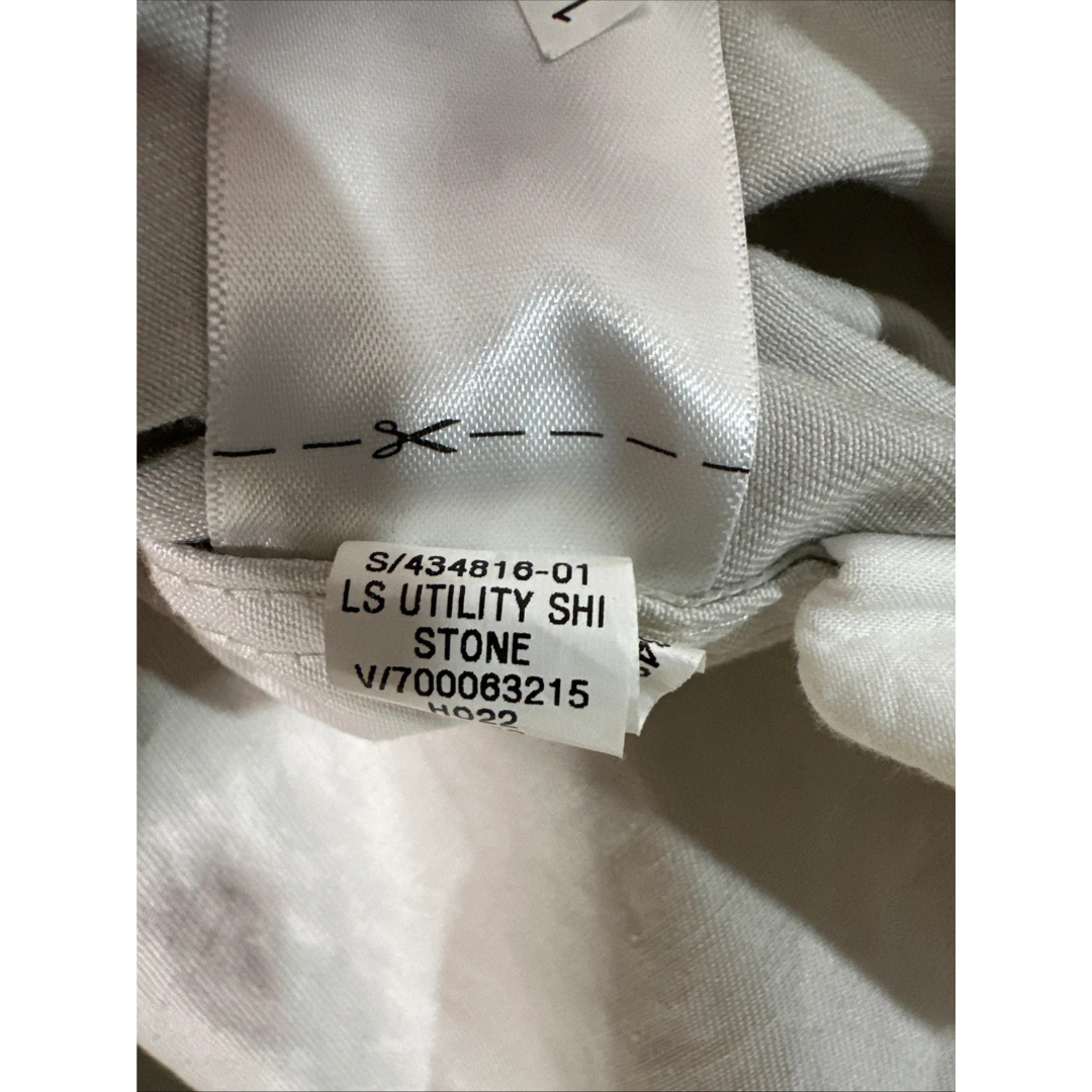 Close-up of a fabric label on a garment with text and numbers.