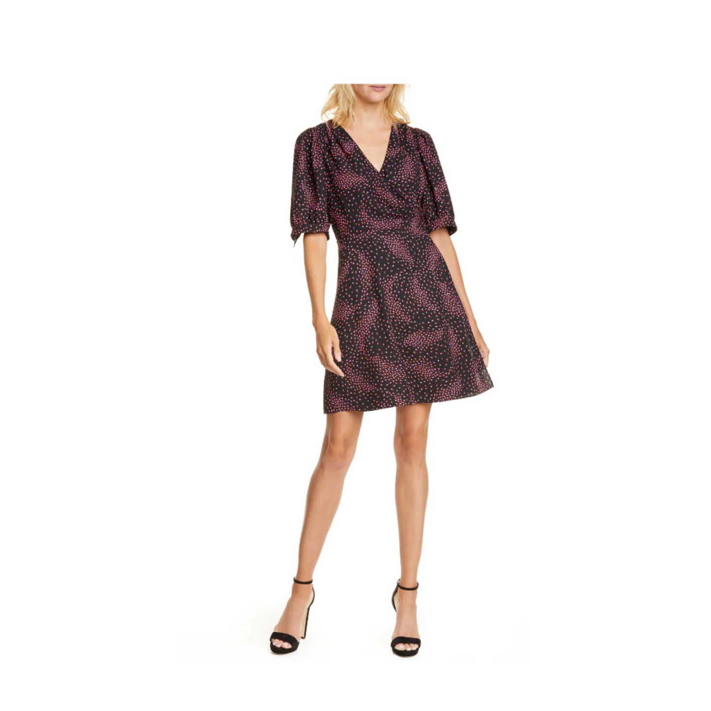 Woman wearing a patterned black and pink dress on a white background