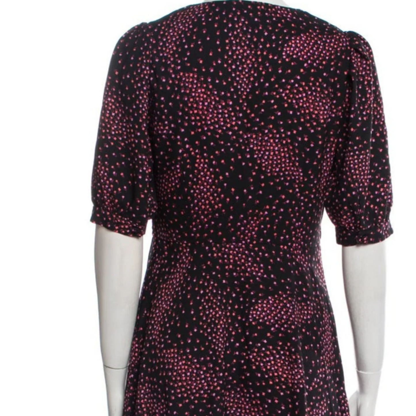 Mannequin wearing a dress with a red and pink pattern on a white background