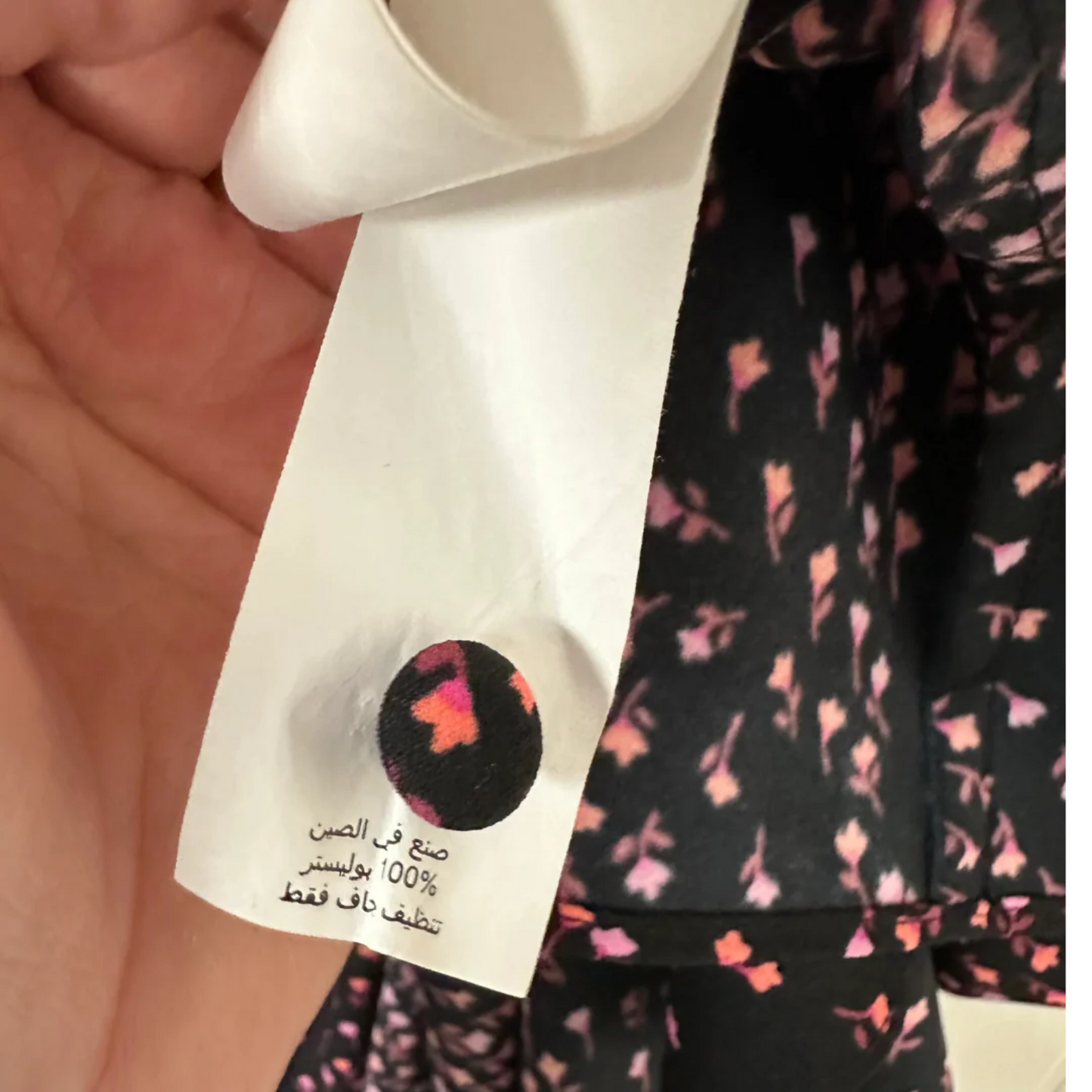 Close-up of a label on a garment with a floral pattern