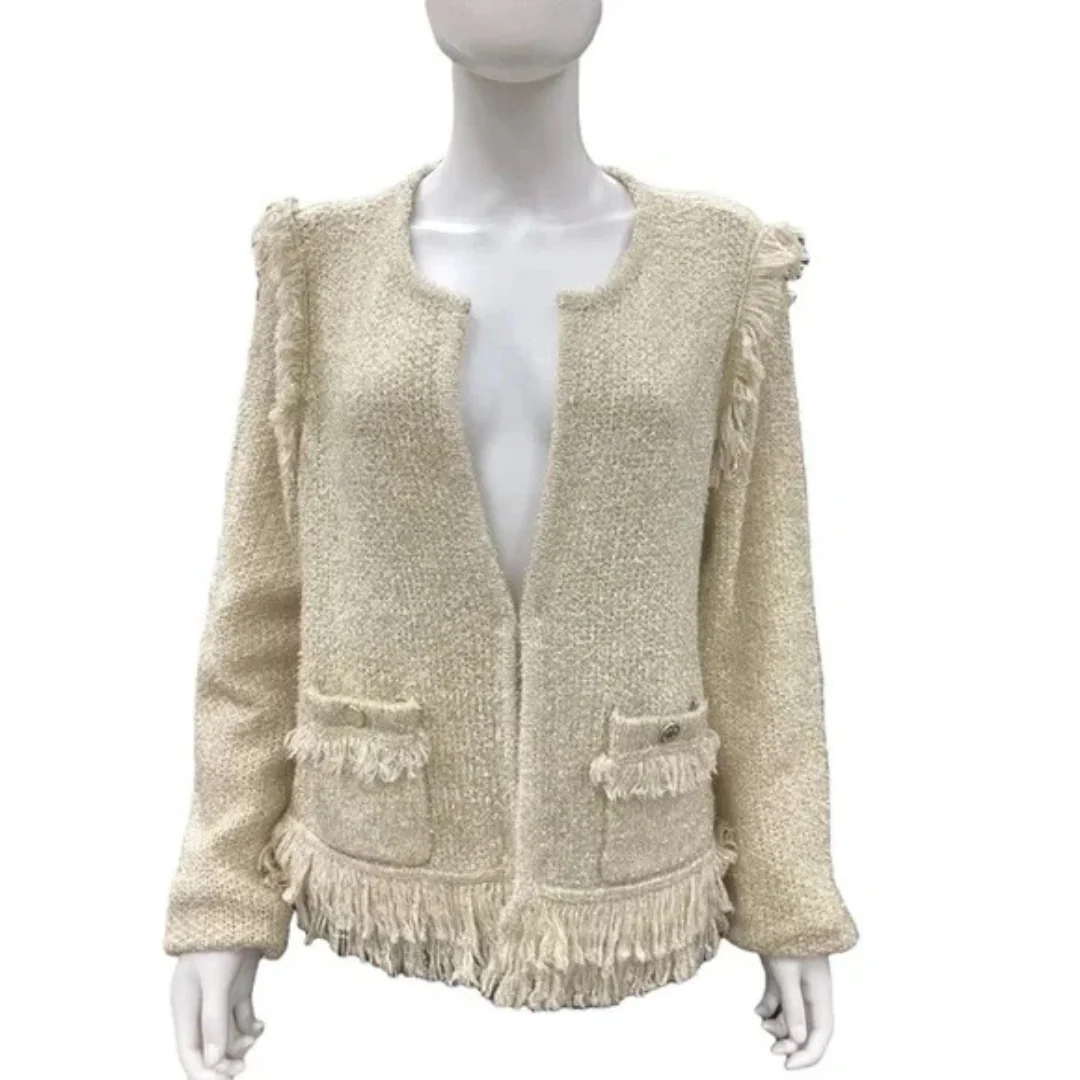 Gold textured cardigan on a mannequin against a white background