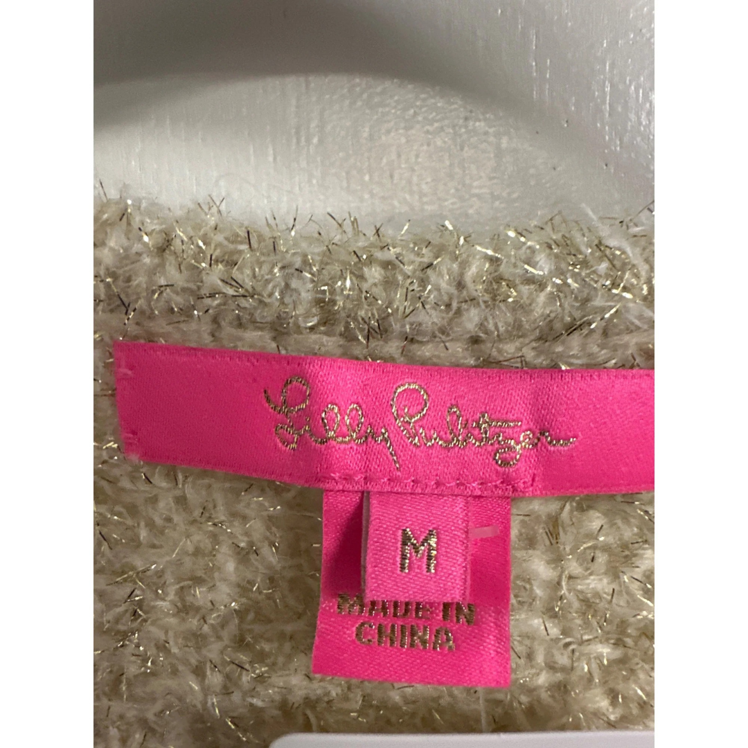 Pink label with Lilly Pulitzer branding and size 'M' on a textured background