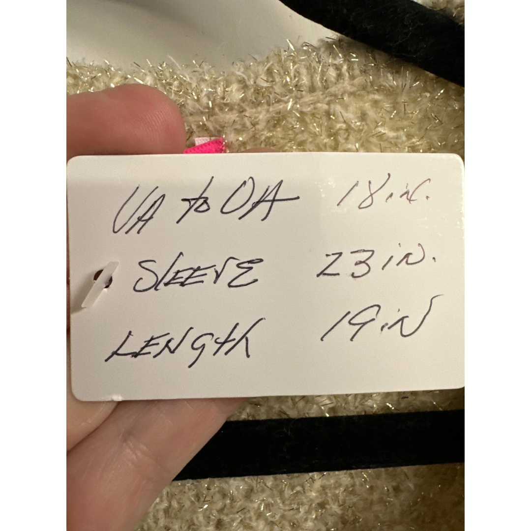 Handwritten label with measurements on a textured surface
