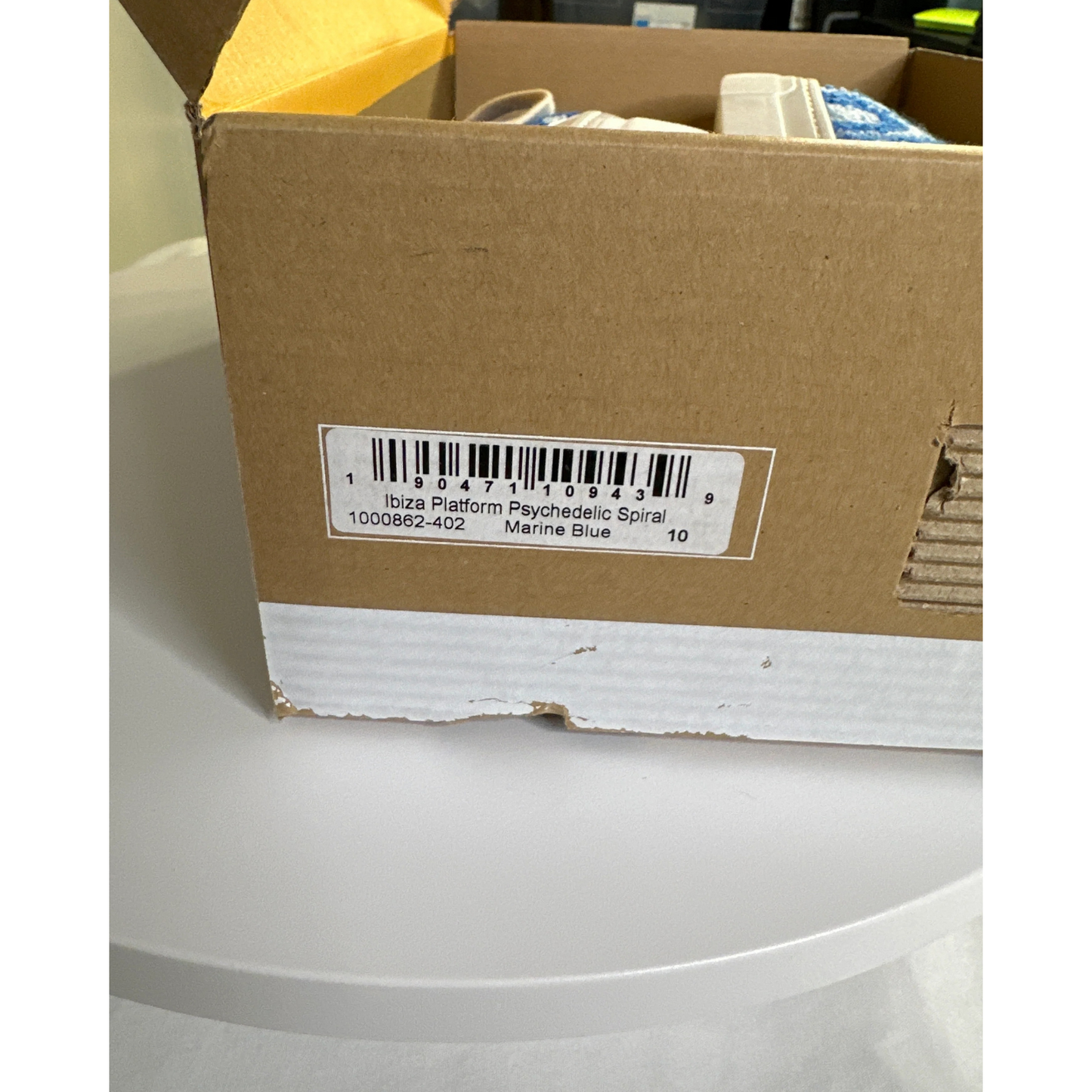 Cardboard box with a barcode label on a white surface