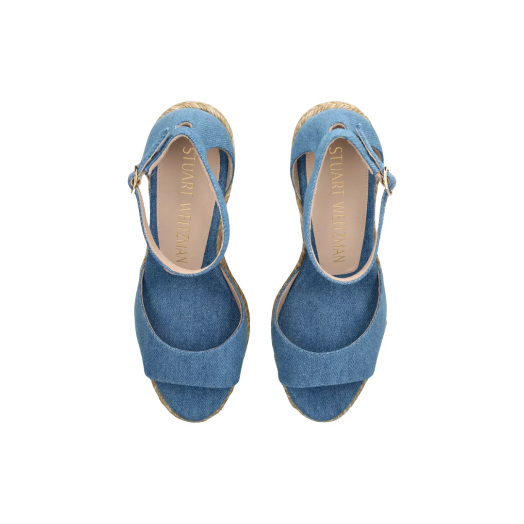 Stuart Weitzman sandals on a white background looking down showing the inside