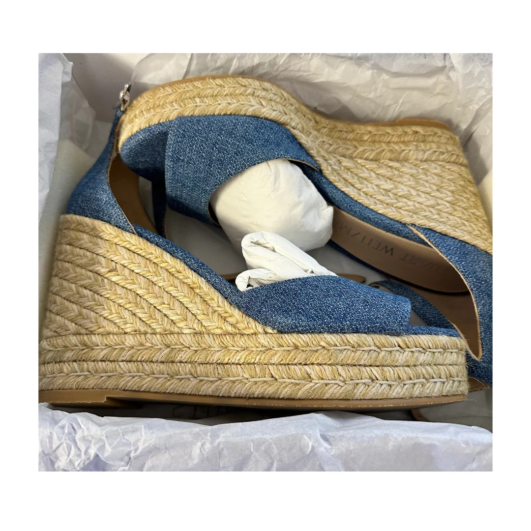 Stuart Weitzman shown in their box sandal with denim uppers on a white background
