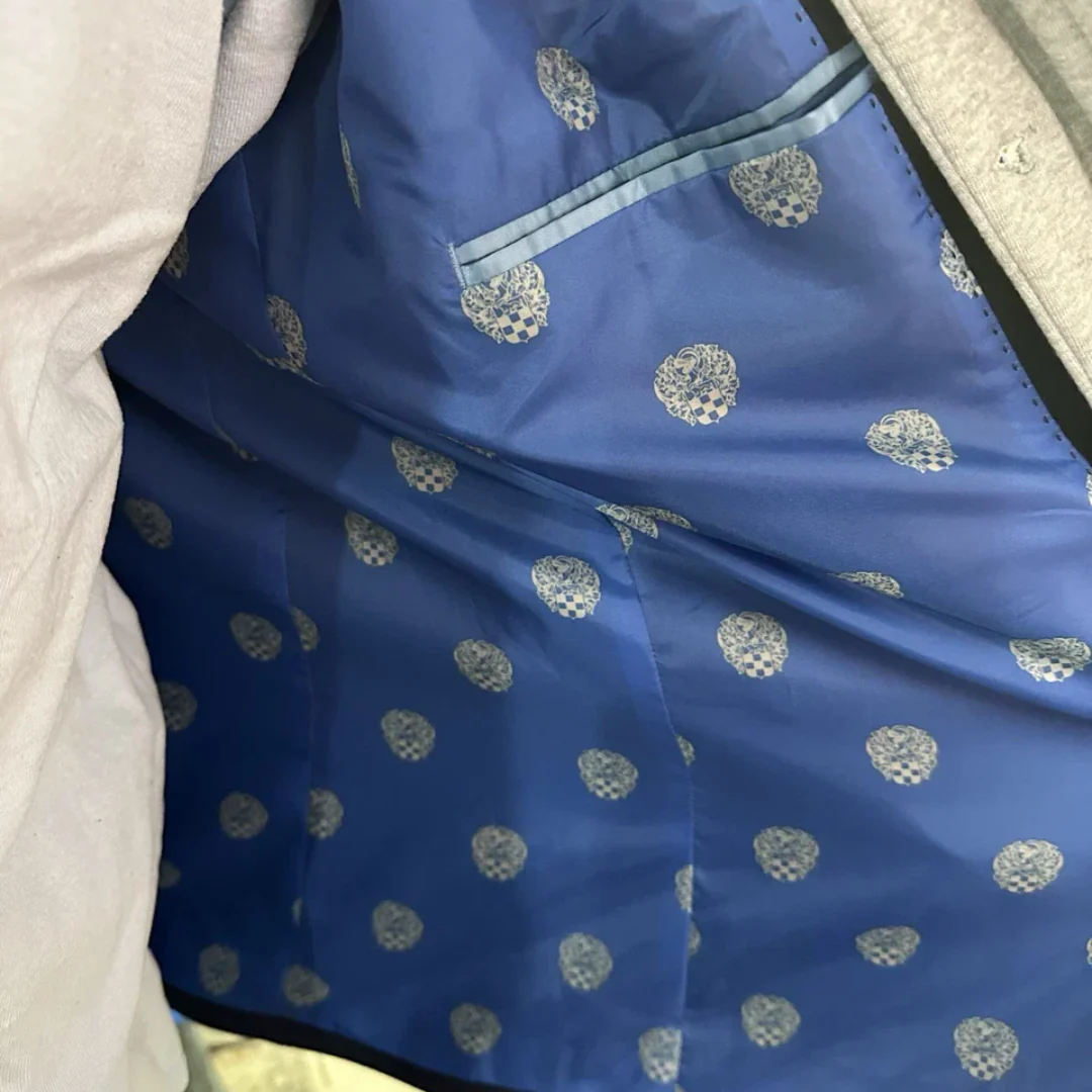 Blue fabric with silver patterns on a white surface