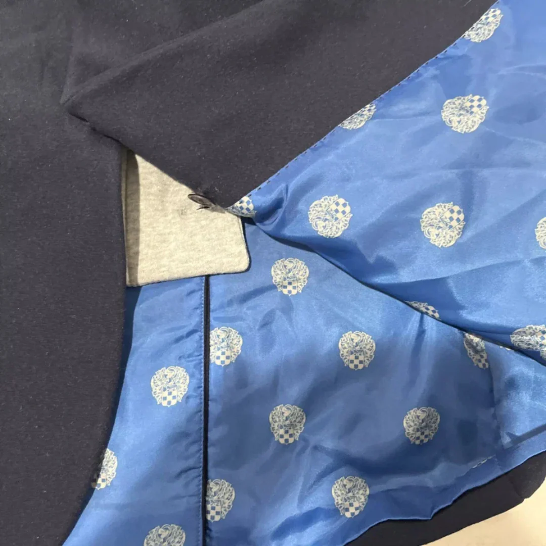 Close-up showing the hooded portion unbuttons and is removeable