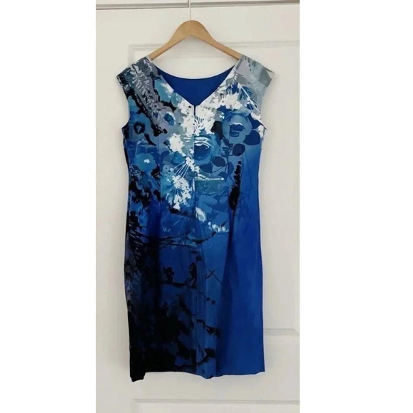 Full view of the back of a Blue floral dress on a hanger against a white background