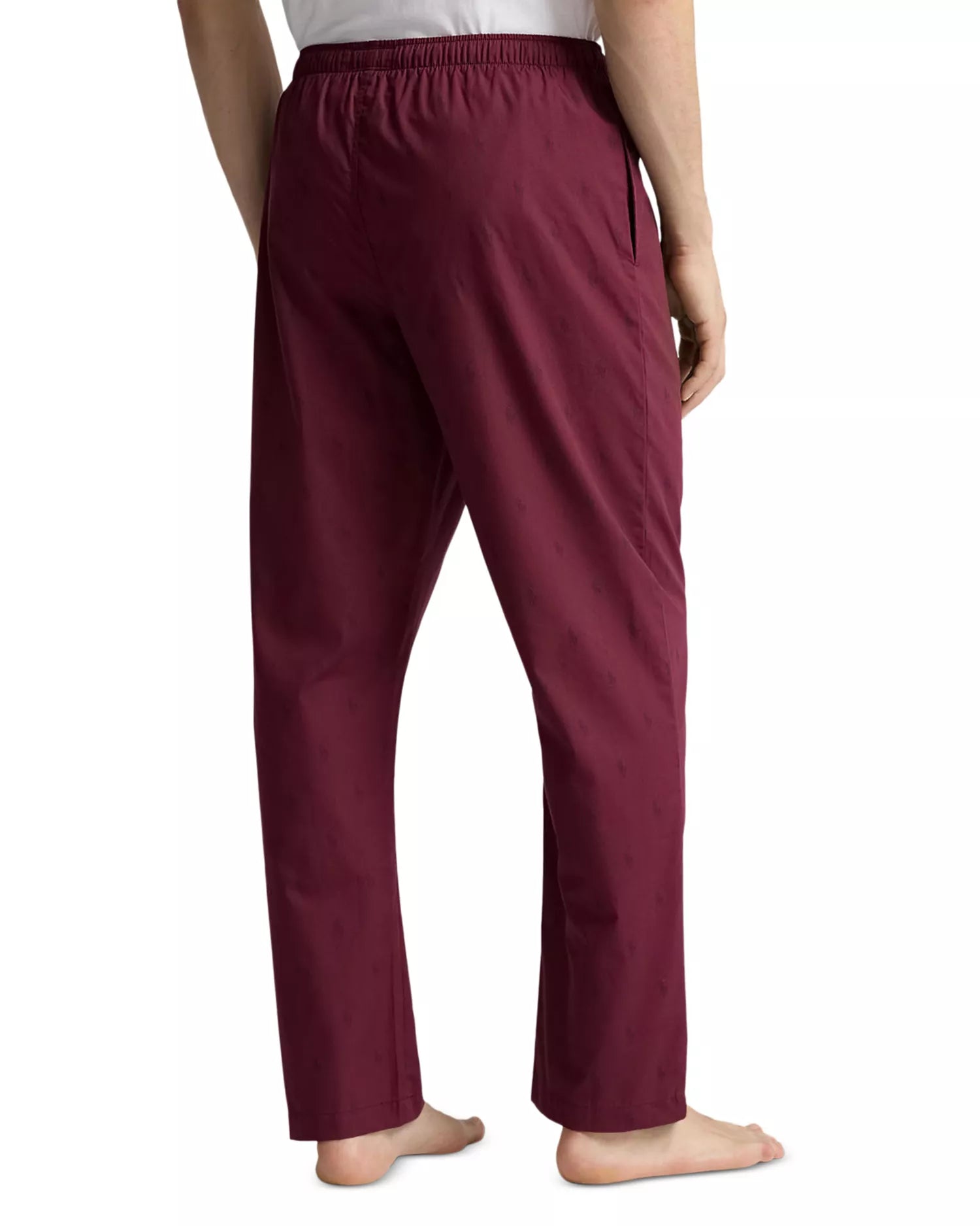 Rear view of a person wearing Polo Ralph Lauren men's wine-colored pajama pants, showing the fit and drape of the woven fabric against a white background.