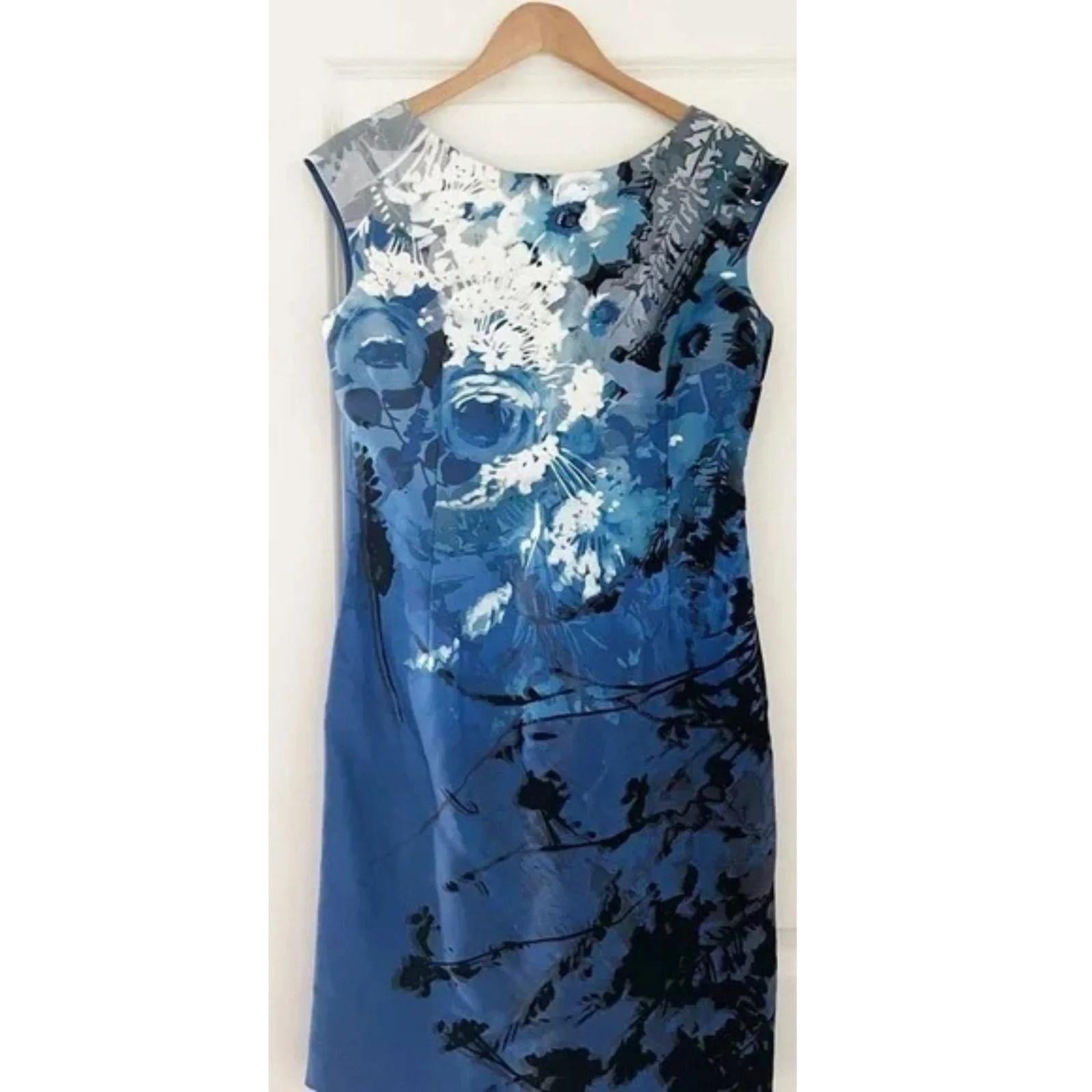 Blue floral dress on a hanger against a white background
