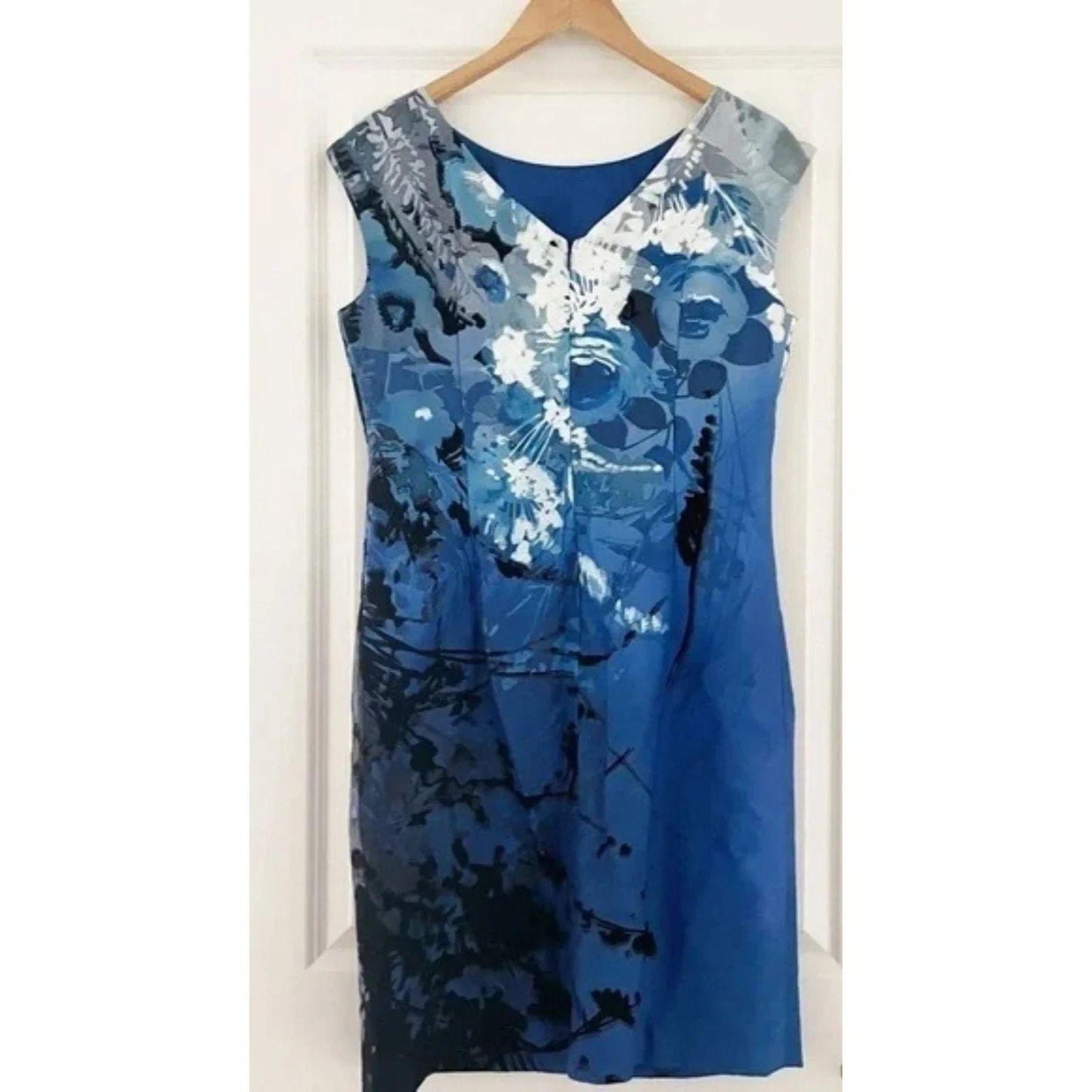 Blue patterned dress on a hanger against a white background