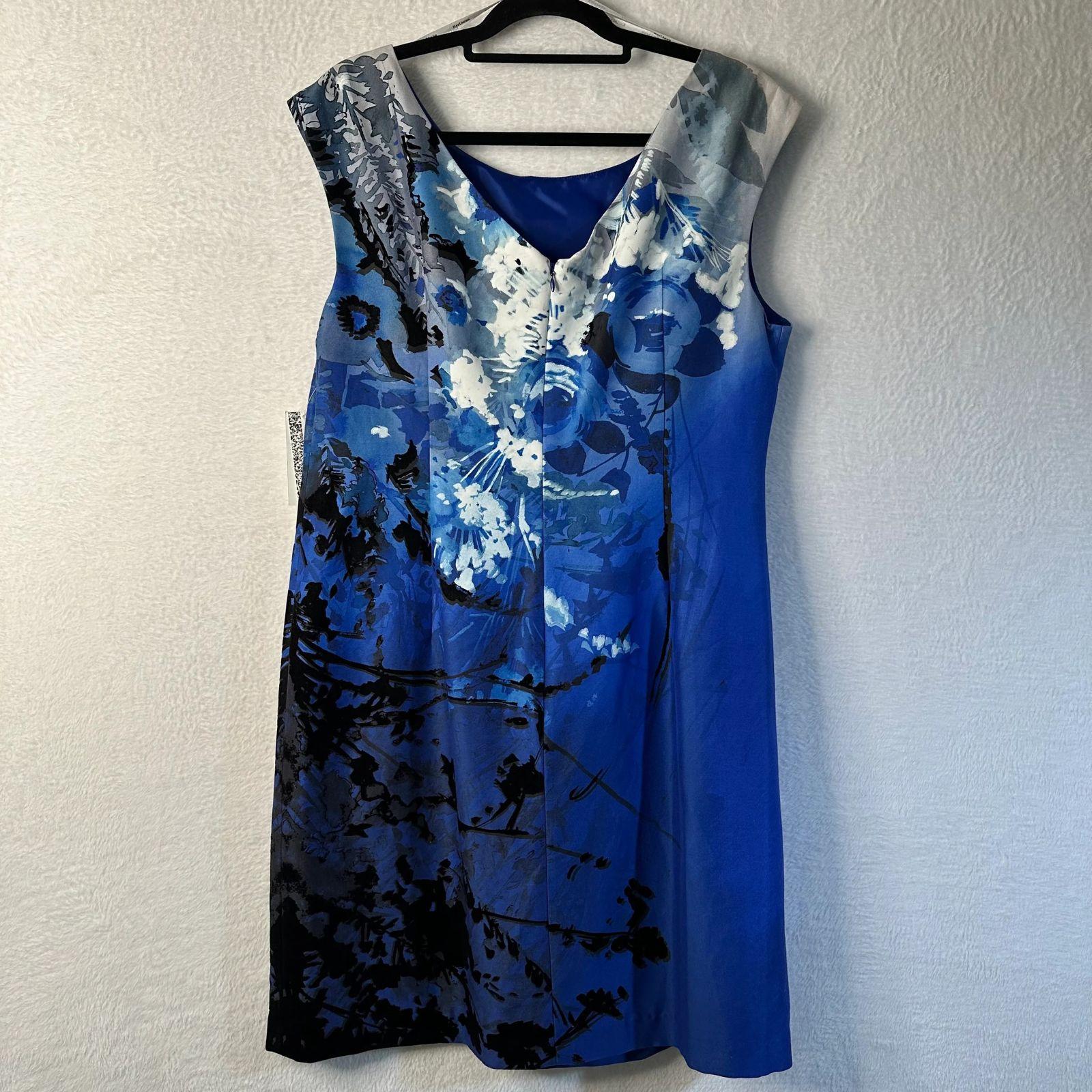 Blue floral dress on a hanger against a white wall