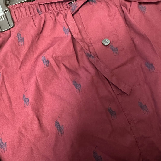 Close-up of Polo Ralph Lauren men's wine pajama pants showing the elastic waistband, single-button fly, and detailed blue pony print.