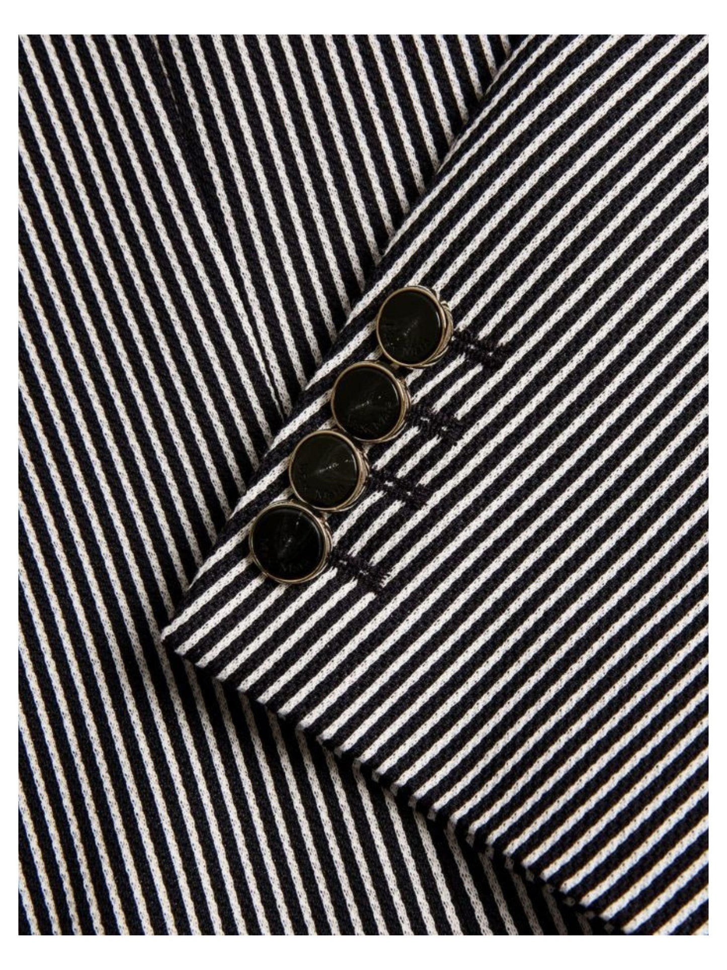 Close-up of a black and white striped fabric with buttons.