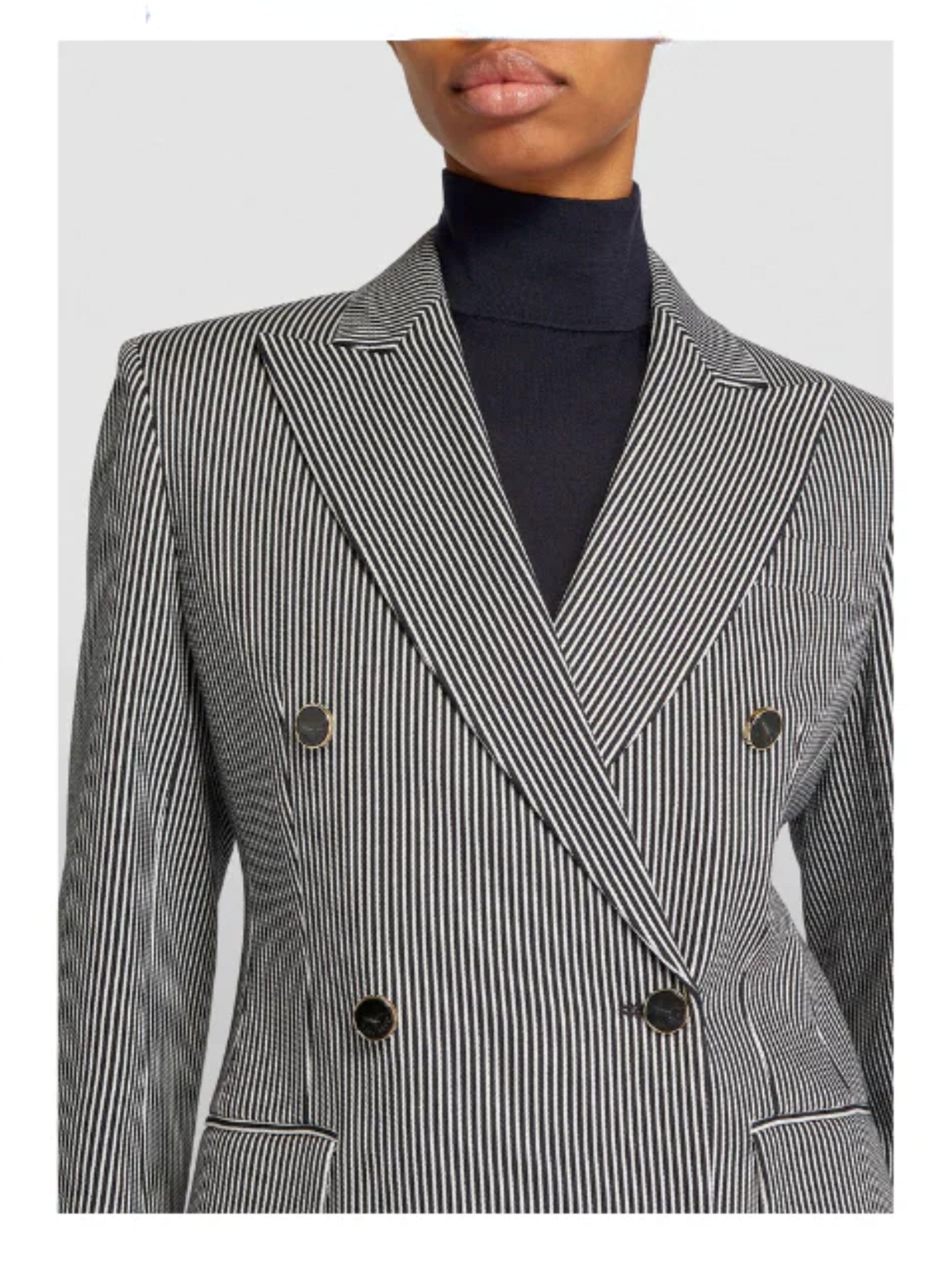 Black and white striped blazer worn by a person on a light gray background