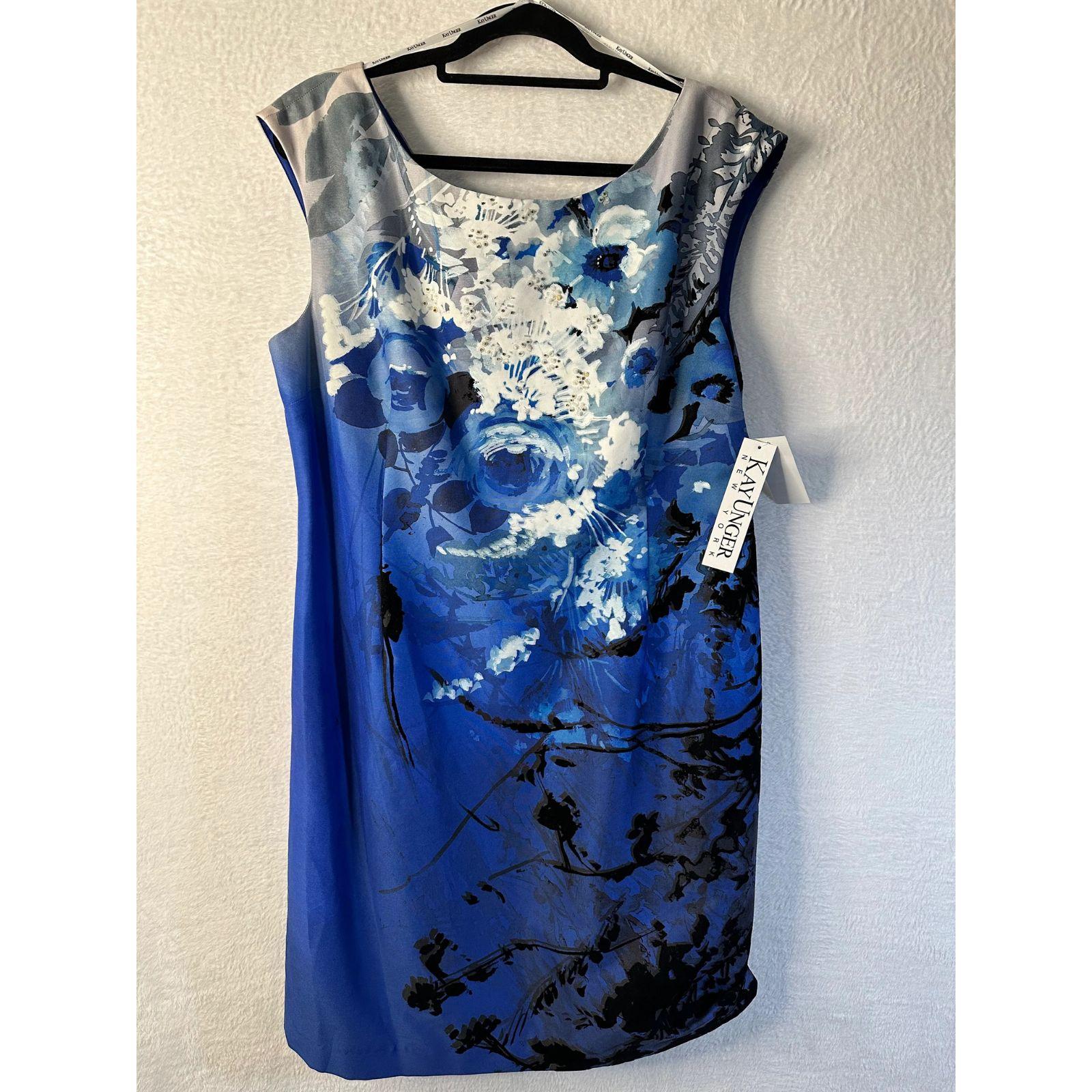 Blue floral dress on a hanger against a white wall