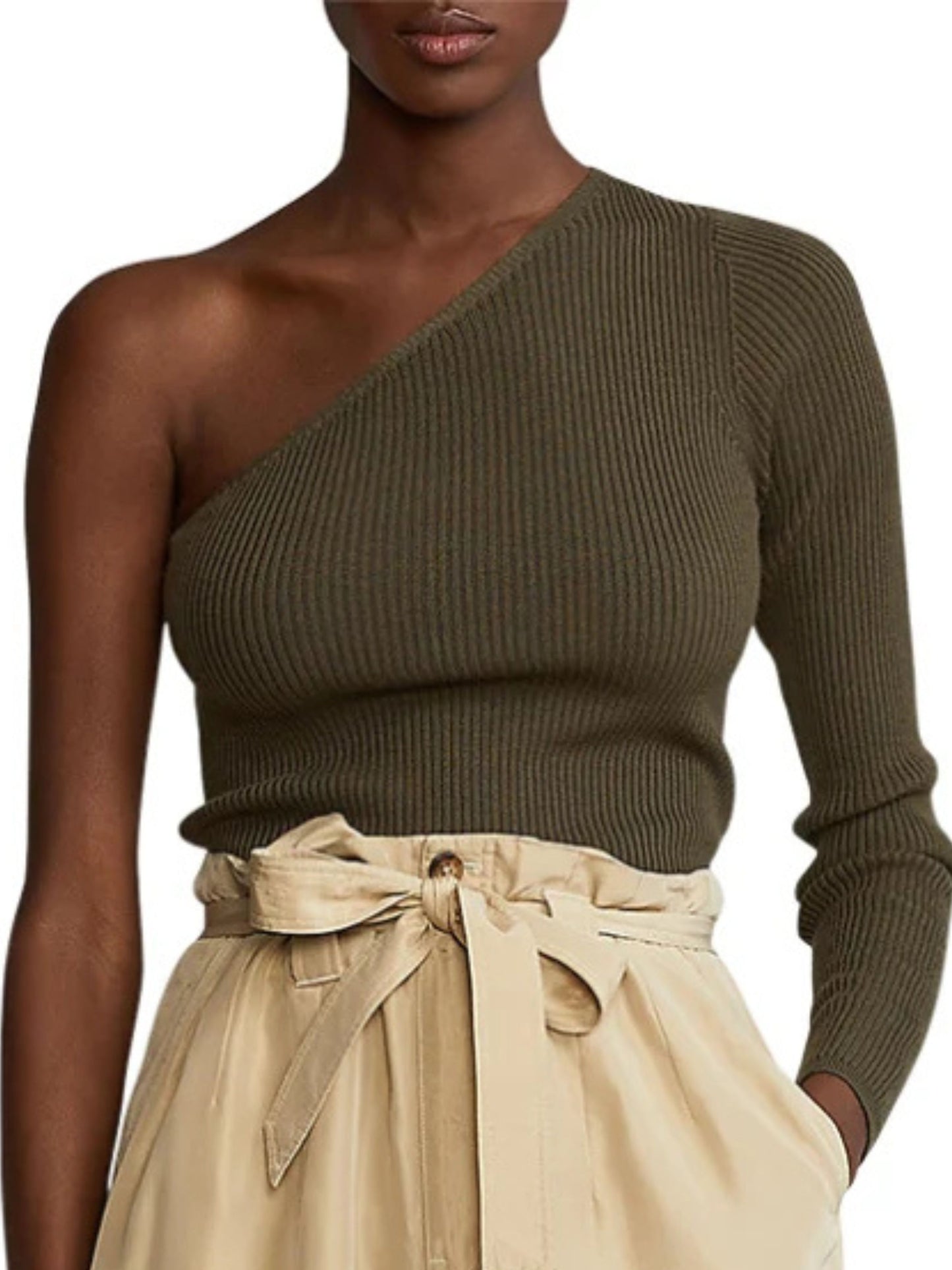 Woman wearing a green one-shoulder sweater and beige pants on a white background