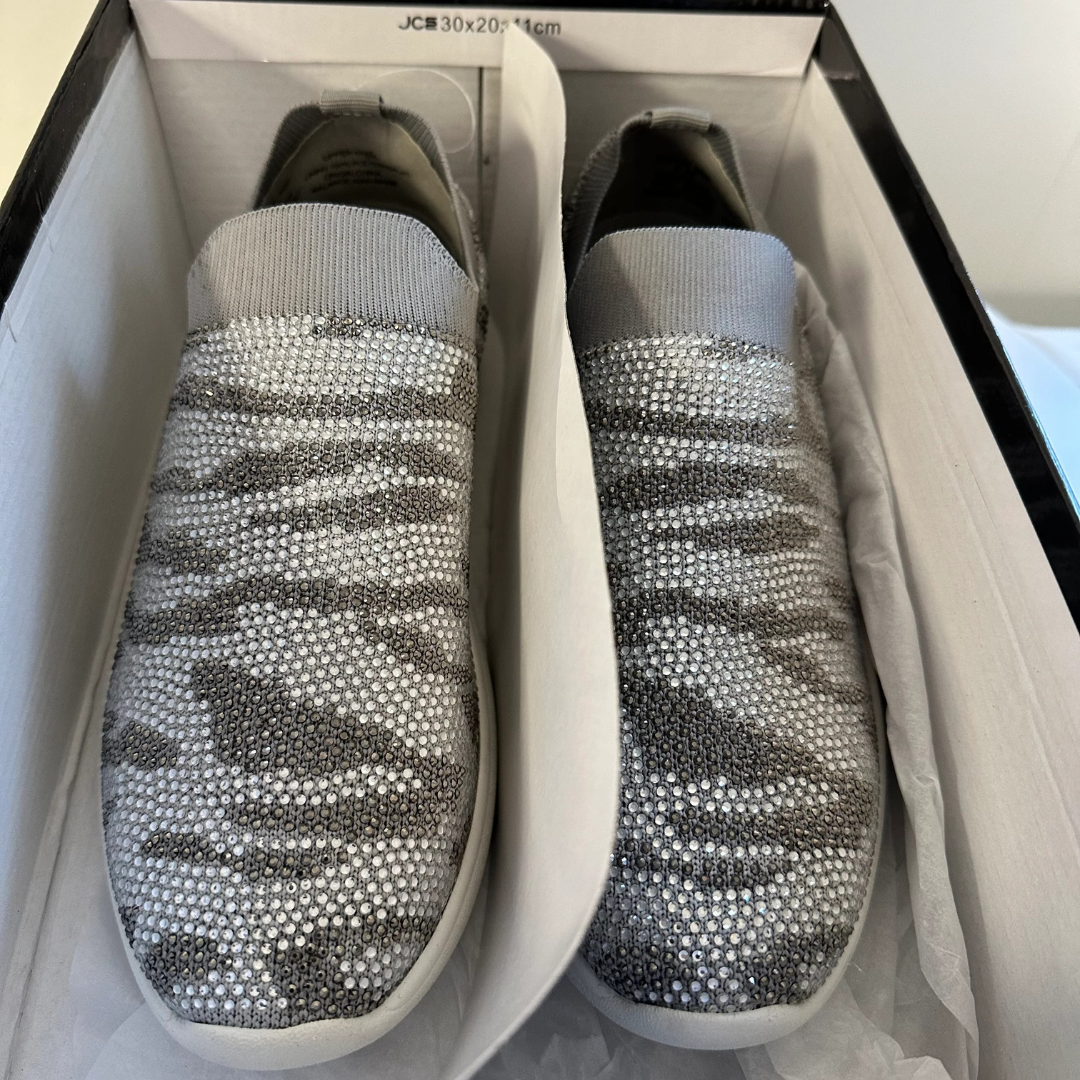 Pair of slip-on shoes with rhinestone embellishments in a box.