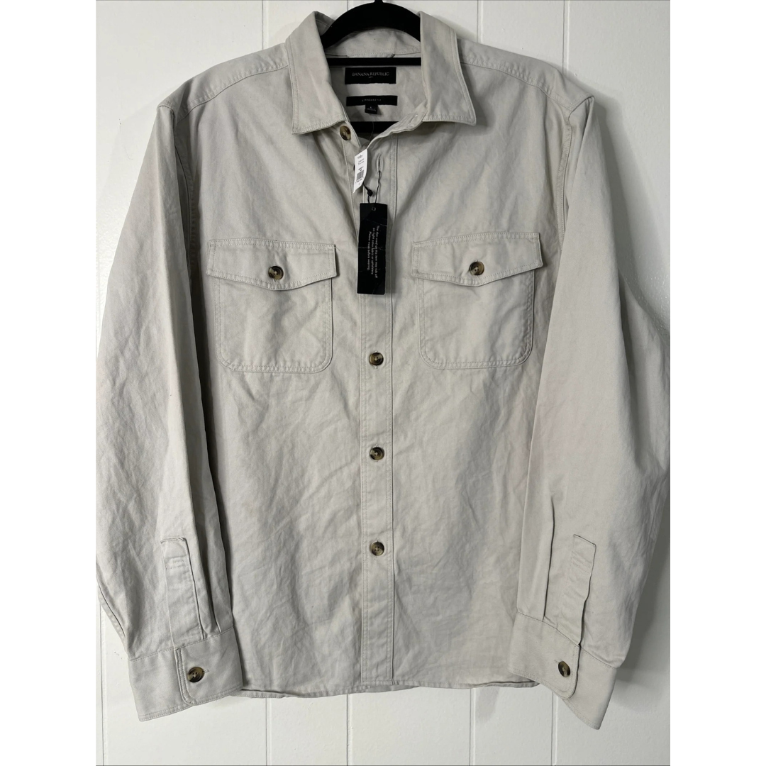 Shirt with buttons on a hanger against a white background
