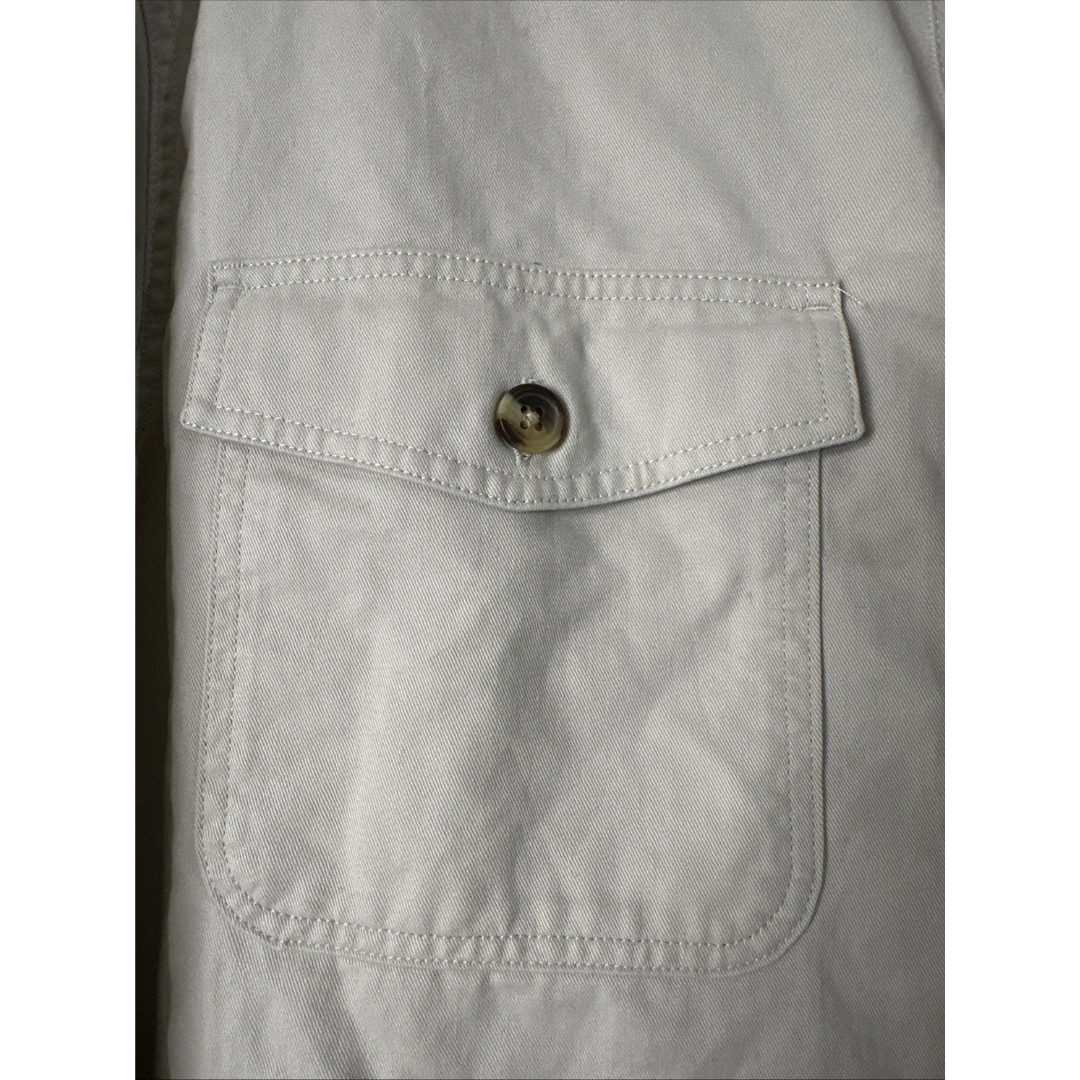 Close-up of a  pocket on a garment with a button.
