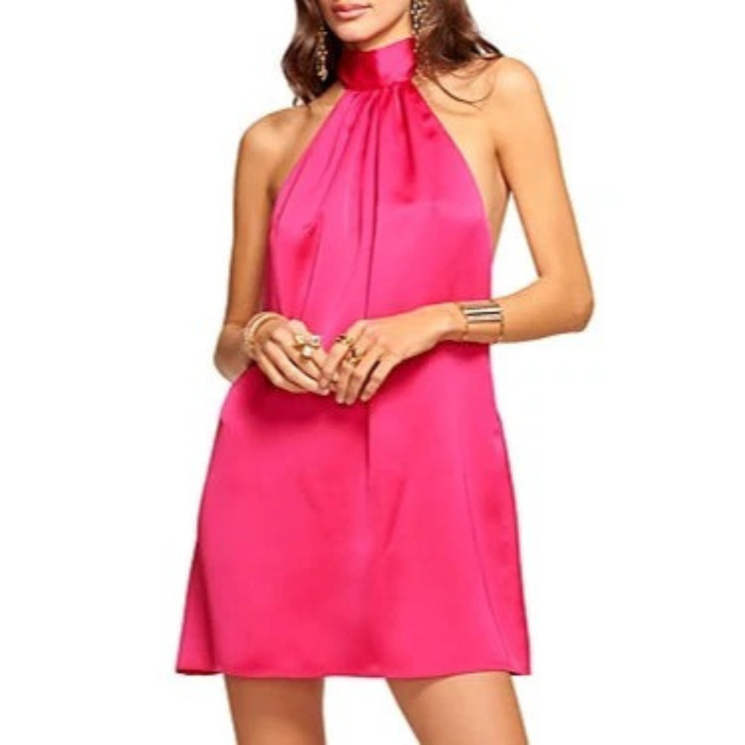 Woman wearing a bright pink halter neck dress on a white background