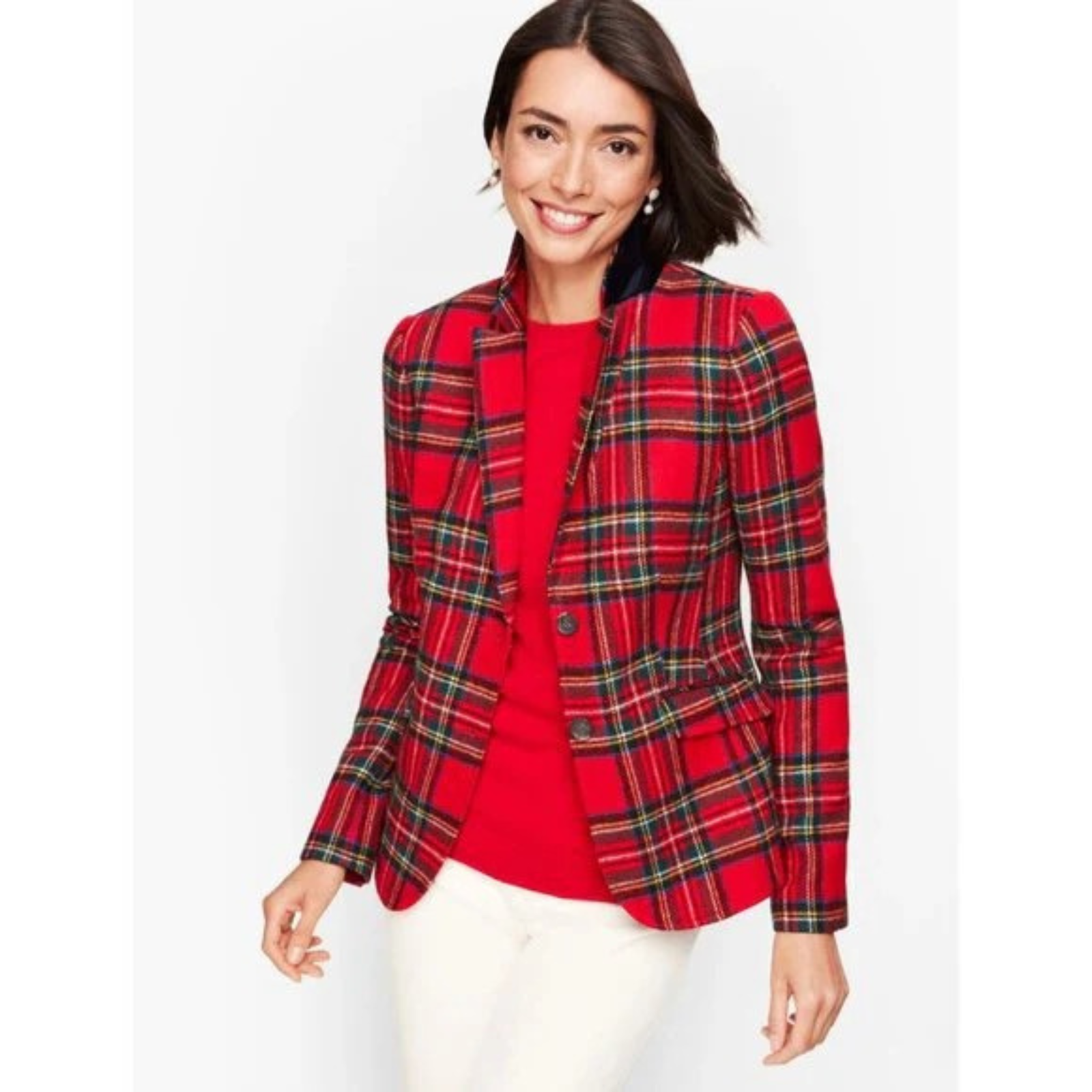 Woman wearing a red plaid blazer over a red top on a white background