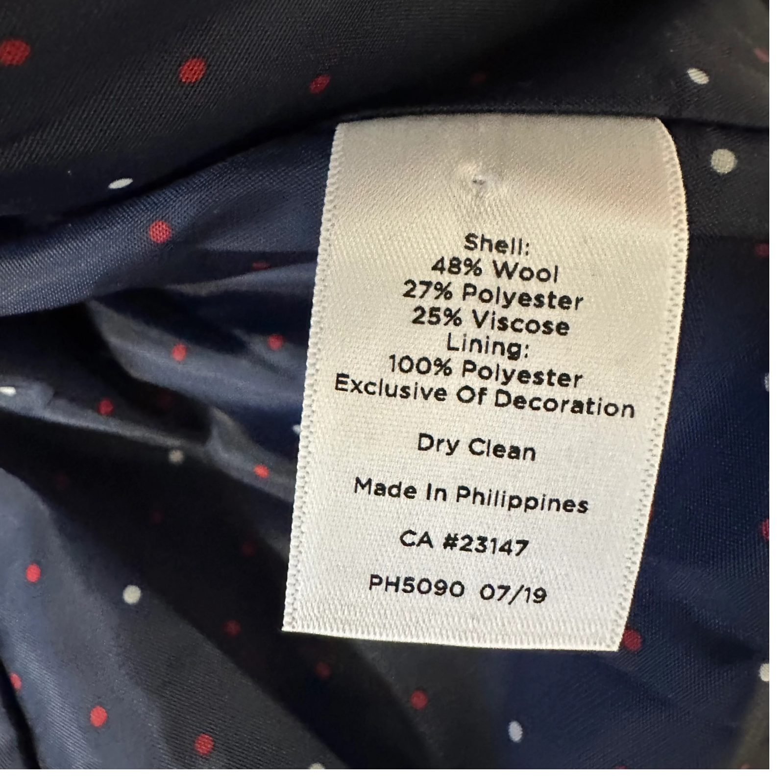 Navy blue and polka dots interior lining with fabric composition and care tag