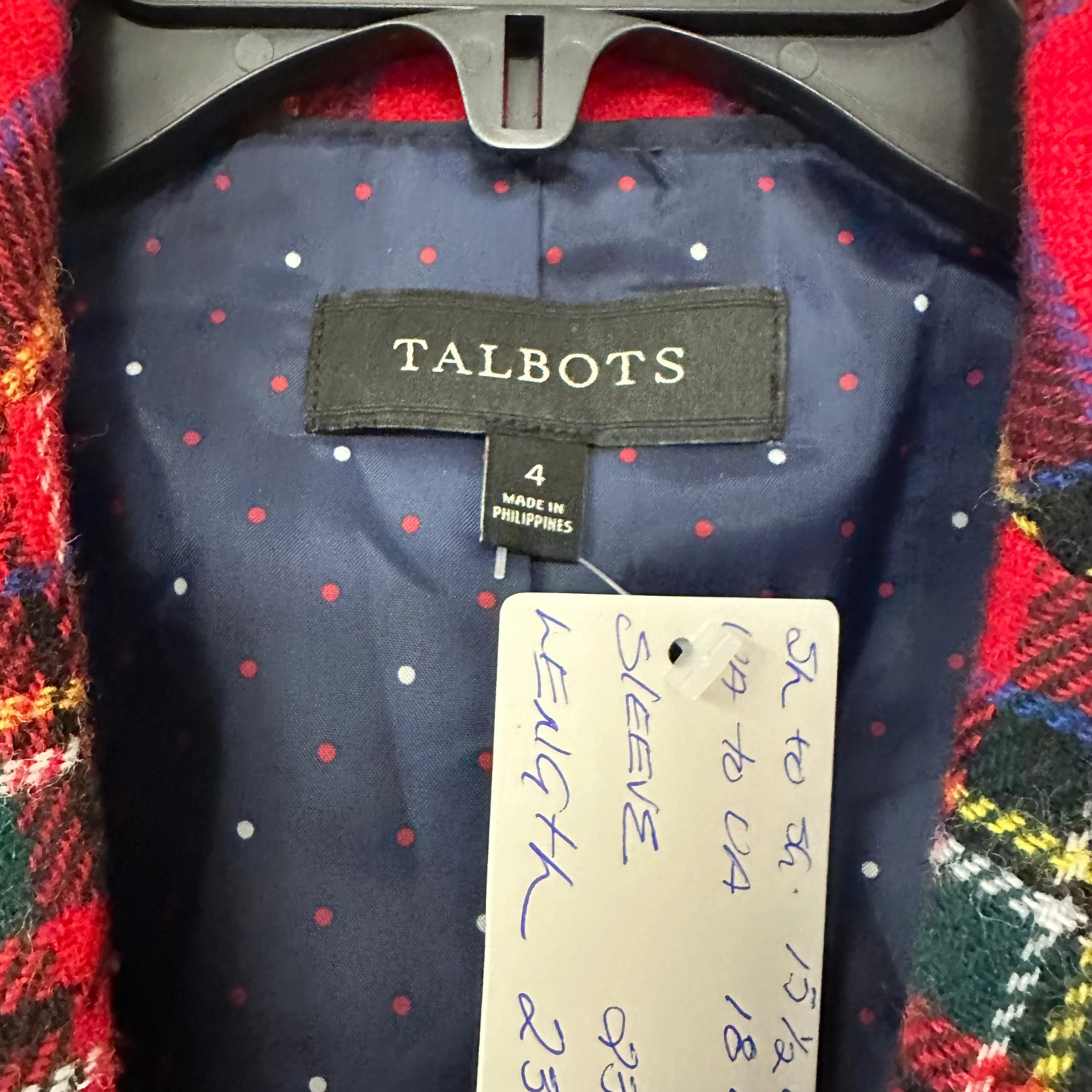 Plaid jacket with red and white polka dots and a Talbots label on a multicolored fabric background.