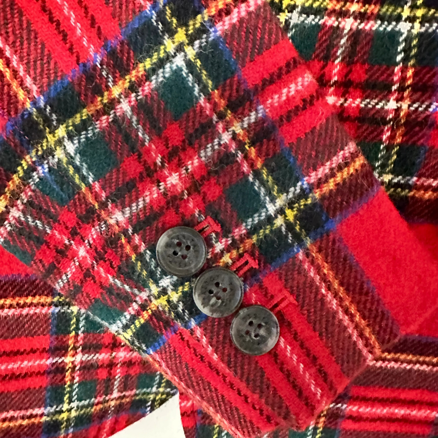 Close-up of a red plaid fabric with buttons