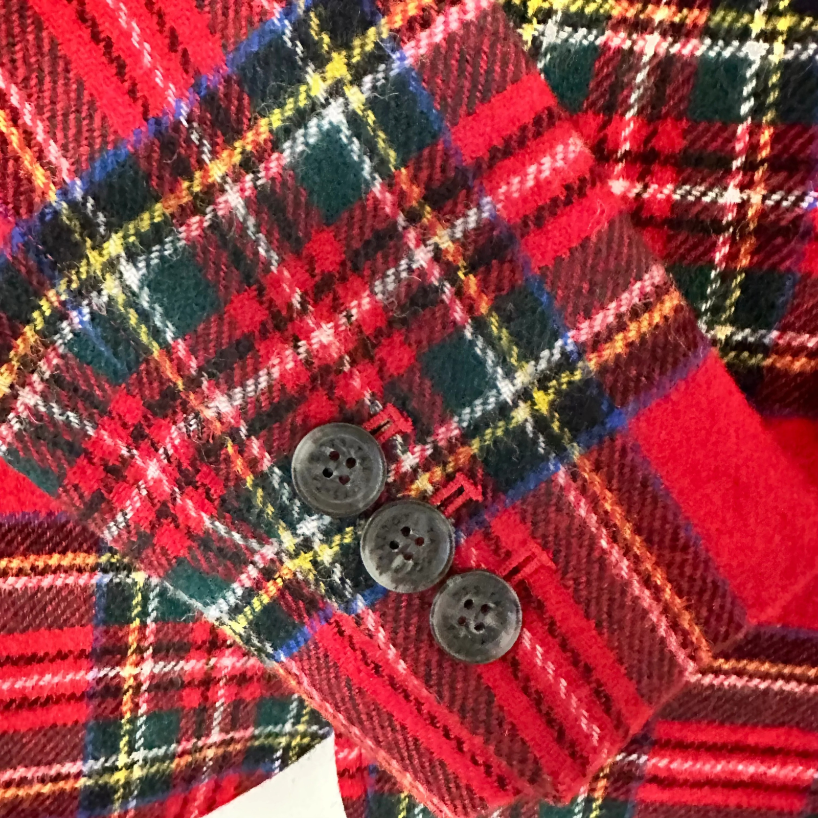 Close-up of a red plaid fabric with buttons