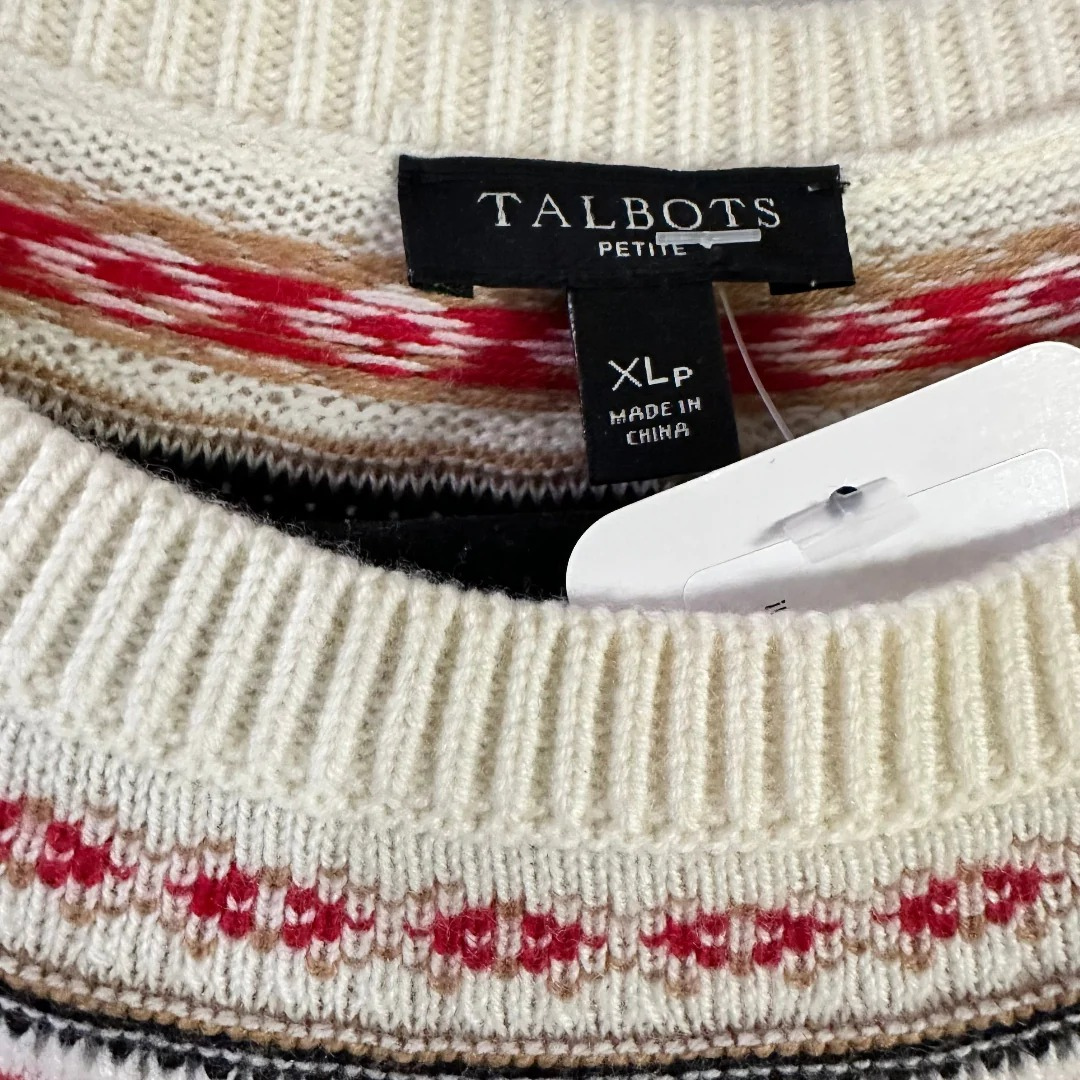 Close-up of a Talbots sweater with a hanger and label.