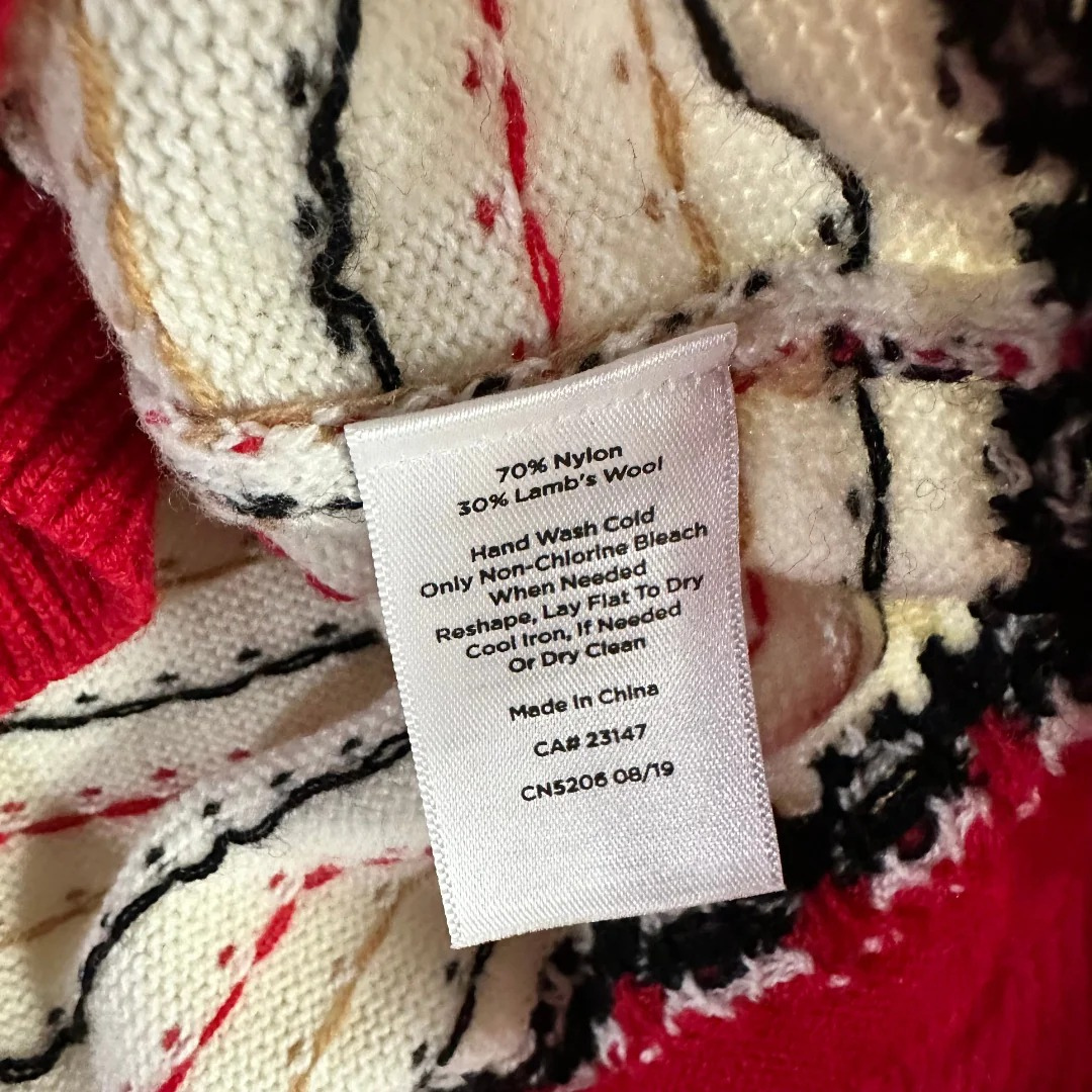 Clothing label on a patterned garment with text details.
