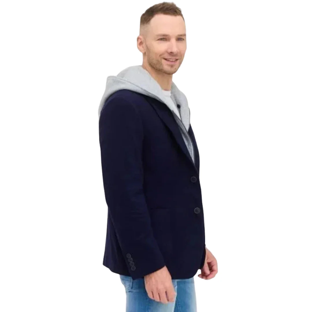 Man wearing a navy blue jacket with a gray hood on a white background