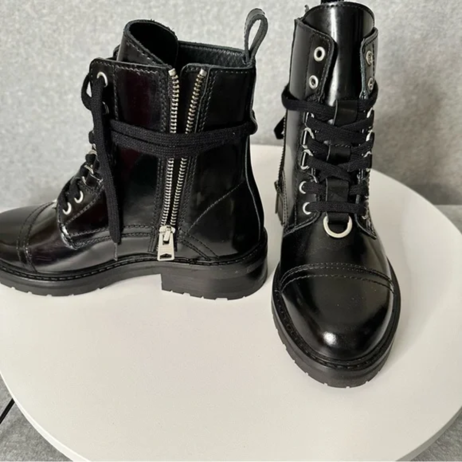 Front and side view of boots featuring side zip with wrap around lace