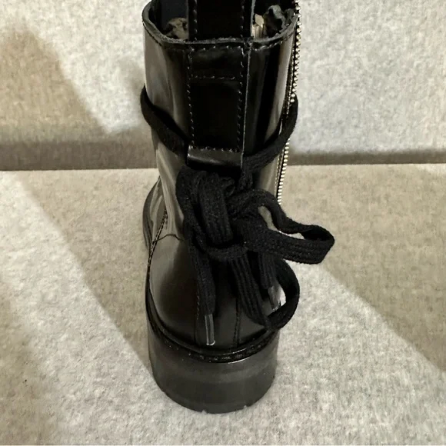 Up-close showing back view of black leather boots