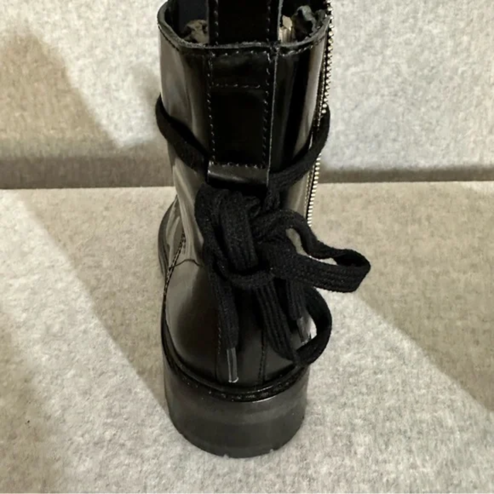 Up-close showing back view of black leather boots