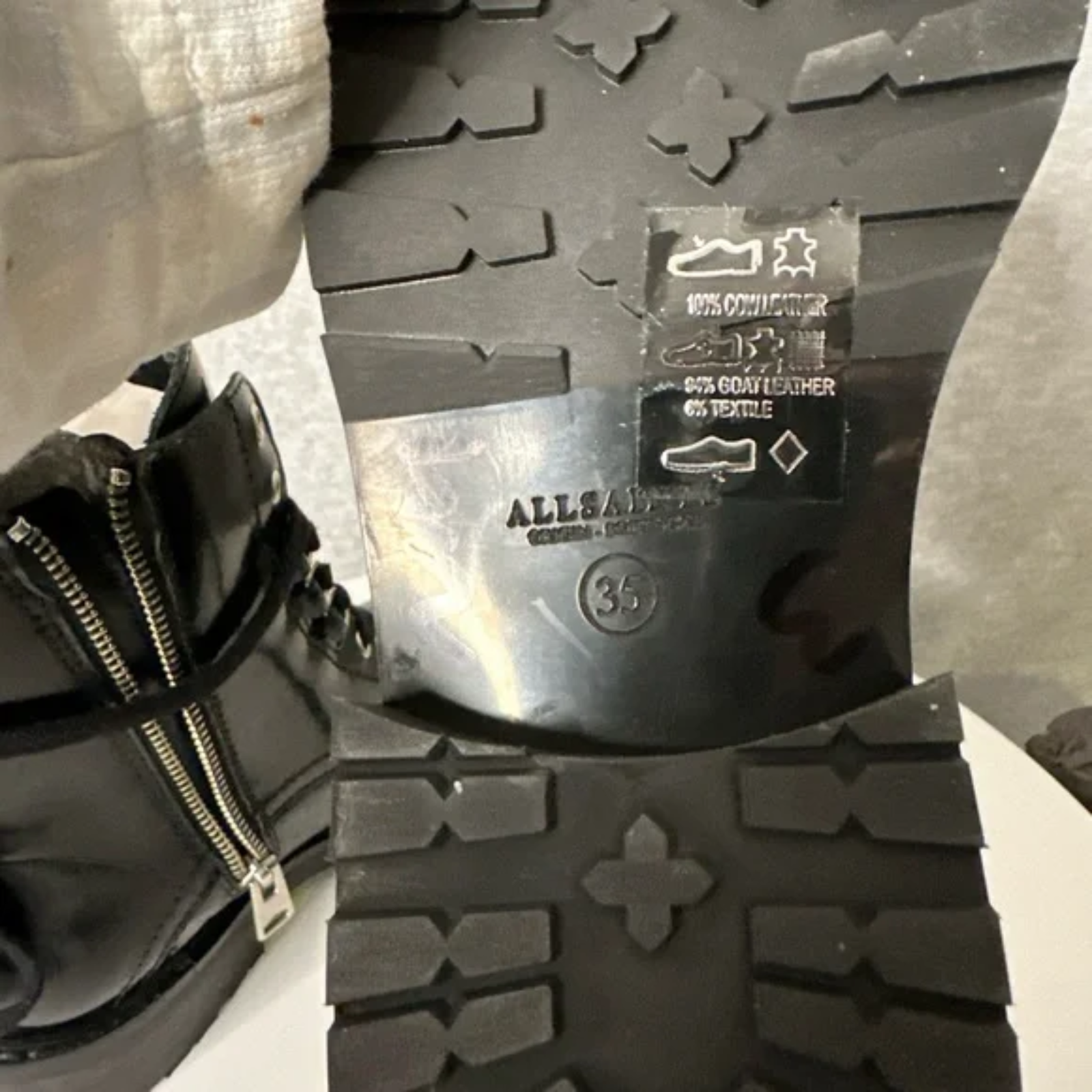 Close-up of a black shoe sole with brand name and size label