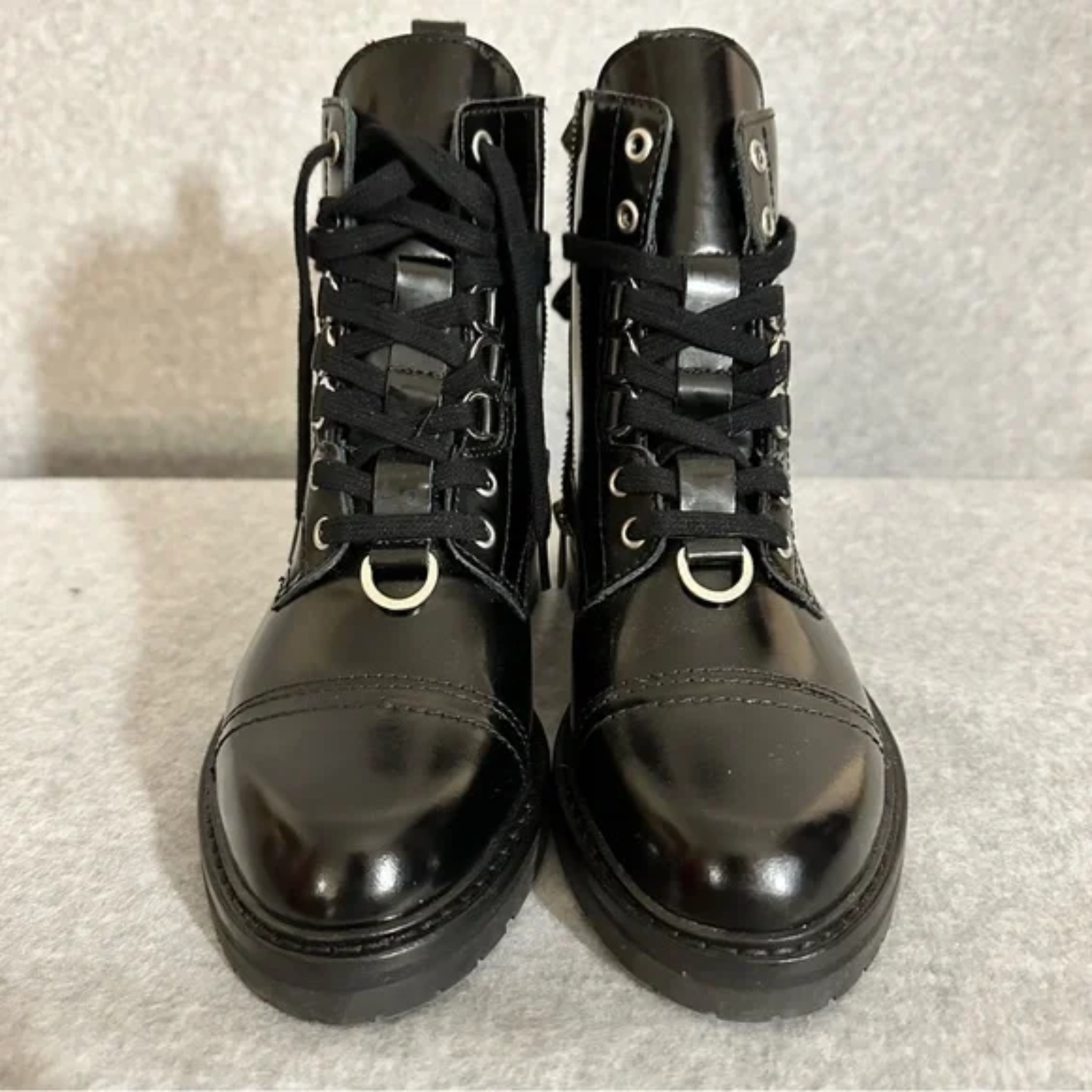 Up-close showing black combat moto boots